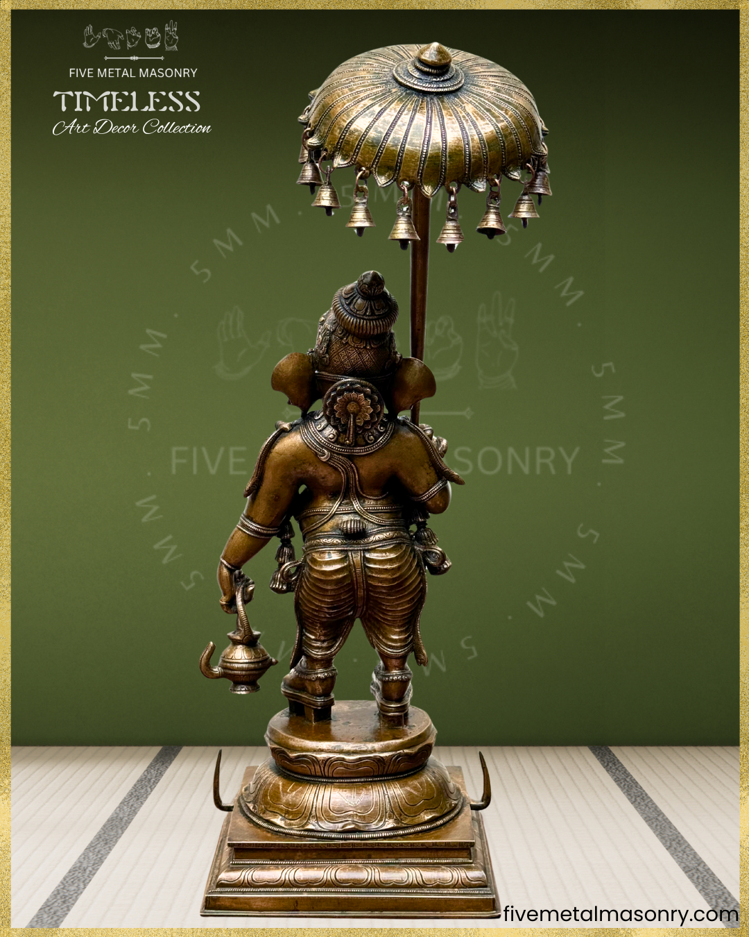Rear view of Panchaloha bronze Ganesha with ceremonial umbrella and kamandalu, standing in graceful yanaka posture, adorned with layered ornaments, karanda makuta and detailed South Indian sculptural craftsmanship from the Timeless collection.