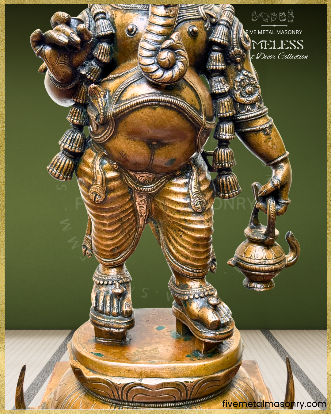 Close-up of antique finish Panchaloha bronze Ganesha highlighting pot belly, coiled trunk, kamandalu, layered ornamentation, detailed drapery, anklets and graceful South Indian sculptural craftsmanship from the Timeless collection.