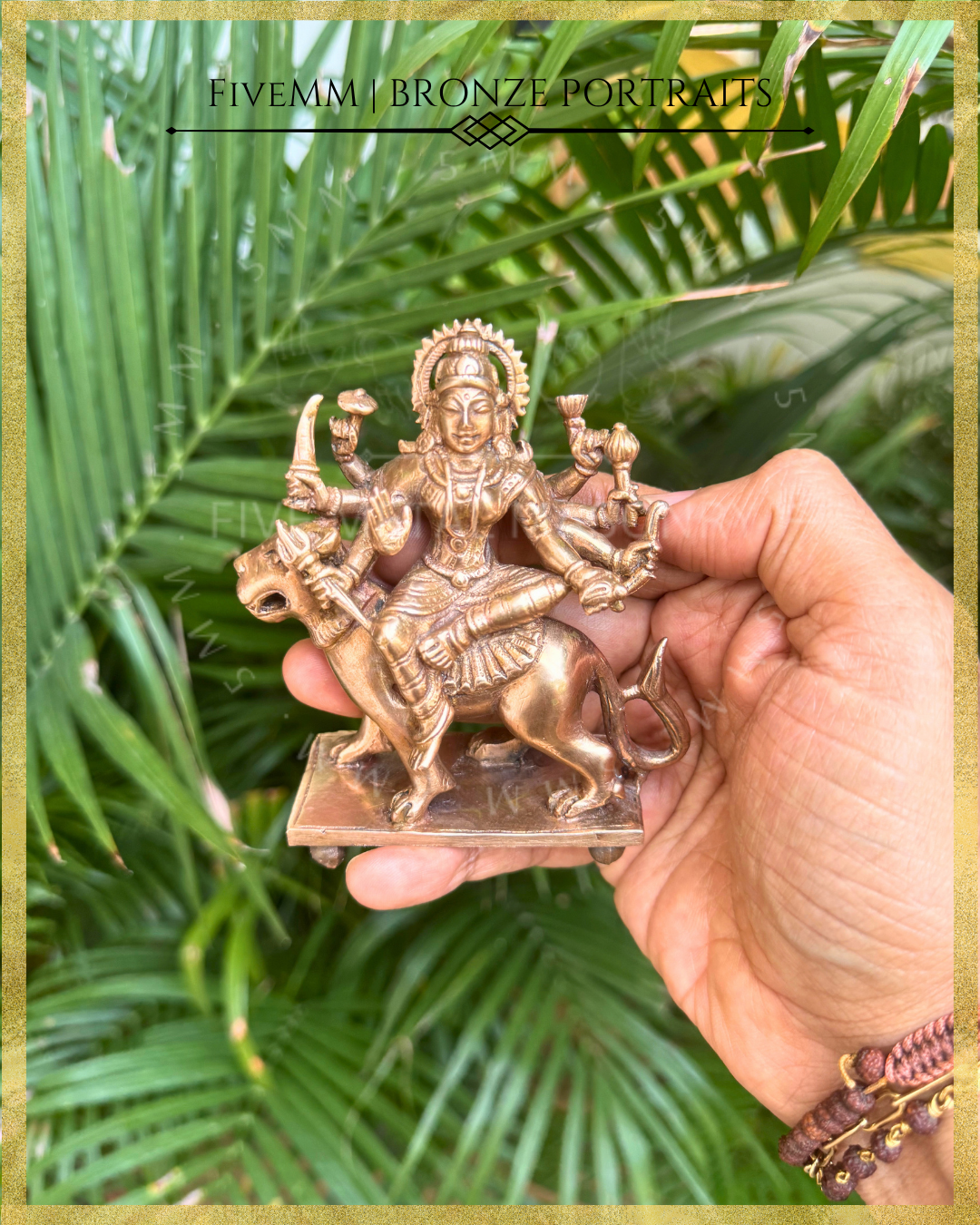 Hand-held view of Handcrafted Durga Panchaloha bronze seated in lalitasana on her simha vahana, eight-armed with cakra, khadga, sula, padma, gada, dhanus and sankha, with abhaya mudra, crafted in the South Indian silpa-sastra and traditional iconographic tradition.