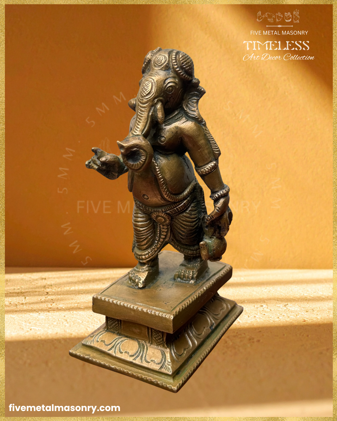 Front angled view of handcrafted Panchaloha bronze Umbrella Ganesha (Mapillai Ganesha) in a walking posture, highlighting the curled trunk, ornaments, pleated garment and water pot, from the Timeless collection, rooted in silpa-sastra tradition.