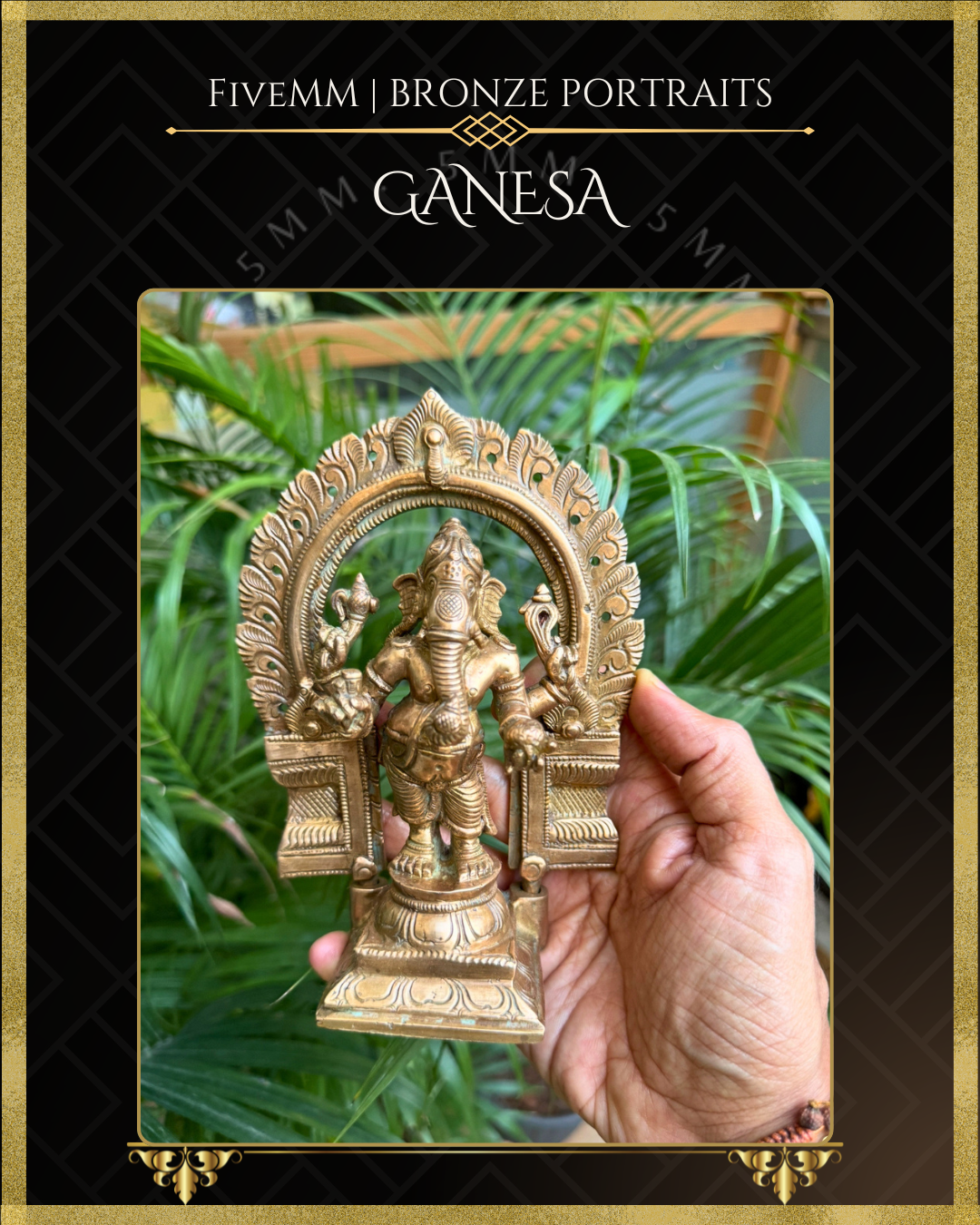 Close-up view of panchaloha Ganesa in seated posture with arch, held in hand; green plants in background.